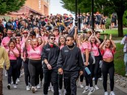 A large group of students walking on campus