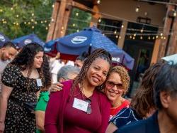 two alumni smiling